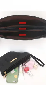 Three-compartment black quilted wristlet with internal zip pocket and organized sections