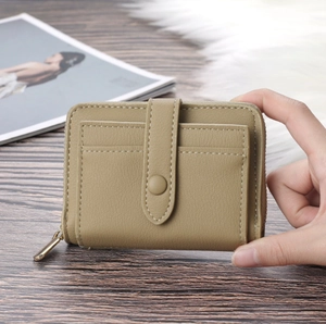 Detail of khaki leather mini purse with zipper compartment and snap button card holder