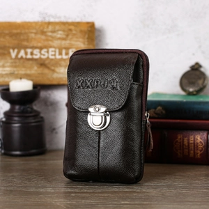 Detail of vintage dark brown leather belt pouch with metal buckle and litchi texture