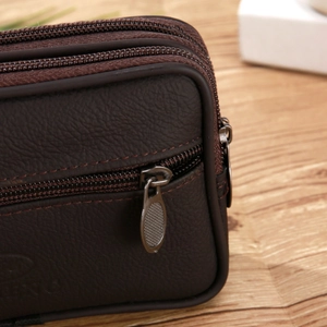 Detail view of brown faux leather waist bag showing multi-layer zipper and stitching
