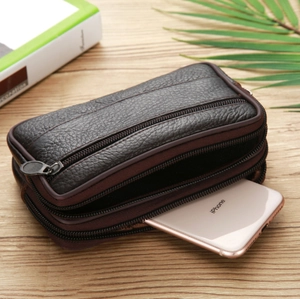 Coffee brown litchi pattern leather waist bag for phone on a wooden surface