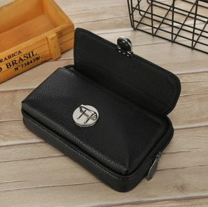 Detail of black lychee grain leather waist bag with silver metal twist lock and zipper