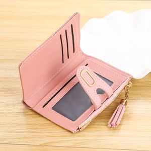 Detail of pink PU leather wallet showing card slots, ID window and fringe zipper pull