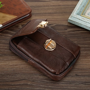 Detail of dark brown leather phone holster with gold metal buckle on a wooden surface