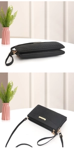 Macro view of black chevron pebbled leather crossbody bag with dual gold zippers