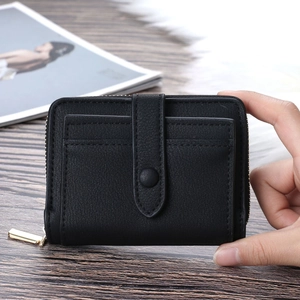 Classic black short PU leather wallet with zipper closure and front card slot held in hand