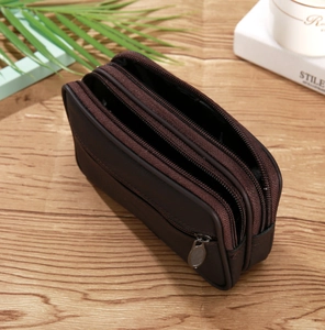 Detail of dark brown faux leather waist bag featuring three secure zippered compartments