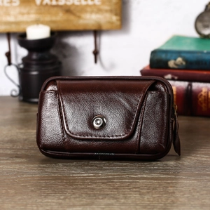 Close-up of brown lychee grain leather belt pouch with zipper and metal snap button