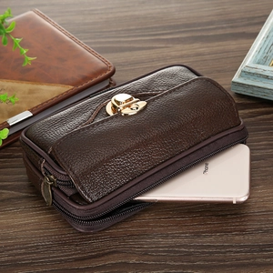 Detail of dark brown leather waist bag with gold buckle and lychee texture for smartphones