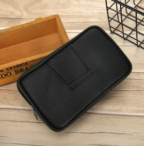 Men's black lychee pattern PU leather waist bag with metal zipper on wooden background