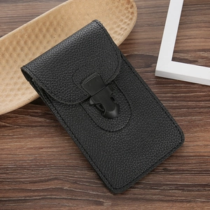 Slim black lychee leather belt pouch for men with a secure flap buckle on a wooden desk