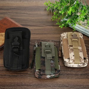Detail of durable tactical canvas waist bags in camouflage and black on wood background