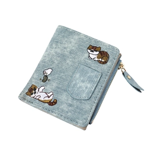 Detailed embroidery of cats on light blue denim canvas wallet with gold zipper closure