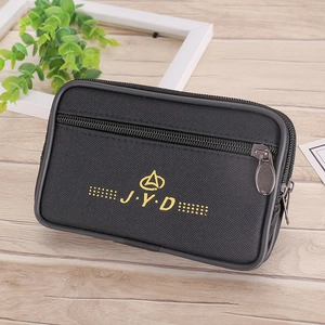 Detail view of the black canvas belt pouch with double zippers and golden J.Y.D logo