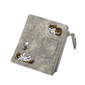 Close-up of grey textured canvas wallet featuring cute cat embroidery and gold zipper detail