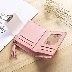 Detail of pink PU leather tri-fold wallet showing card slots, photo window and tassel charm
