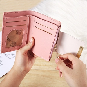 Inside view of pink bifold wallet with card slots, ID window and tassel zipper pocket