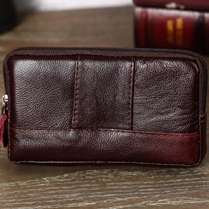 Detail view of premium dark brown leather phone pouch with cross stitching and metal zipper