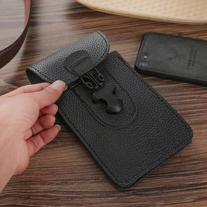 Detail showing the snap buckle closure and lychee texture of the leather phone waist bag