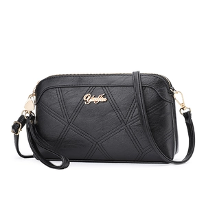 Fashionable black shell crossbody bag for women featuring geometric diamond stitching pattern