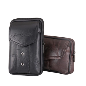 Close-up of textured leather waist bag showing the zipper and embossed logo details