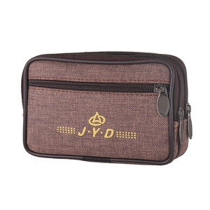 Close-up of brown canvas waist bag showing triple zippers and durable fabric texture