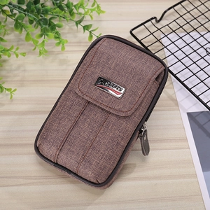 Detail view of brown canvas mobile phone holster with sports metal tag and zipper pocket