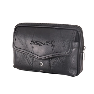 Detail view of the black leather waist bag showing the zipper and textured front pocket