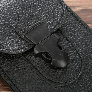 Macro detail of black lychee leather phone pouch with durable plastic buckle and stitching