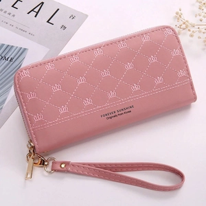 Pink quilted long wallet featuring crown embroidery, wristlet strap, and gold zipper