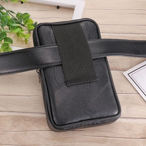 Detail showing the back belt loop of a black waterproof canvas phone waist bag