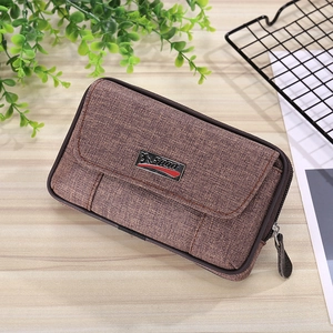Brown canvas tactical phone holster with Sport metal plate on wooden tabletop