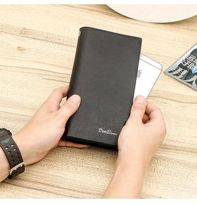 Black leather long wallet for men showing storage capacity next to a smartphone