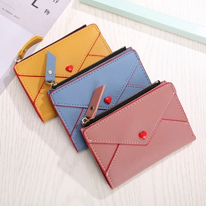 Three envelope-style PU leather wallets in yellow, blue, and pink with heart buttons
