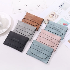 Detailed top view of frosted vintage card holders in five elegant colors on a stylish desk