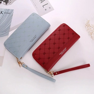 Detailed view of quilted long wallets with crown embroidery and golden zippers