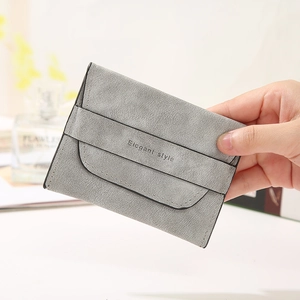 Slim grey matte leather card holder with Elegant Style print held in hand