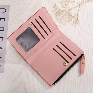 Detail view of pink interior card slots and zipper compartment in a women's PU leather wallet