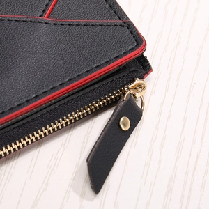 Close-up of heart PU leather card holder with red oil edges and golden zipper detail