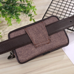 Detailed back view of canvas belt pouch showing leather loop and metal zipper design