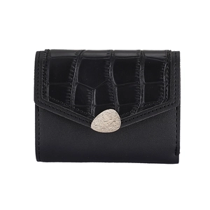 Detail of black faux leather mini wallet featuring embossed crocodile texture and silver clasp