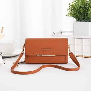 Detailed view of brown PU leather crossbody bag with gold accents and textured finish