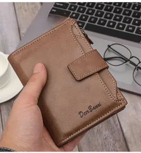 Brown leather men's wallet with lychee texture held by hand in office setting