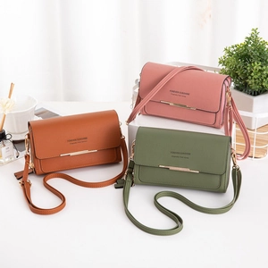 Detailed view of textured PU leather crossbody bags with metal bar in three colors