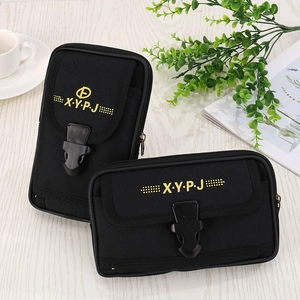 Black canvas waist bag for men with multi-layer storage on white wooden background