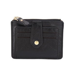 Close-up of black leather slim wallet featuring card slots and gold snap button closure