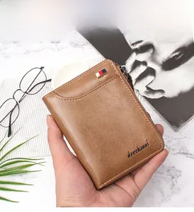 Detailed view of a brown vintage leather wallet with zipper and textured finish