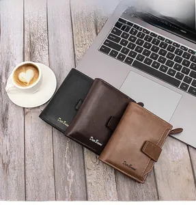 Business style wallets in black and brown leather on a desk with a laptop
