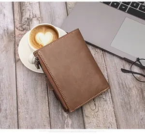 Brown leather wallet on a wooden desk with laptop and coffee for a refined lifestyle view