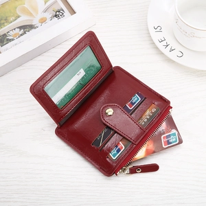 Detailed interior of a burgundy leather multi-card wallet with slots and zipper pocket